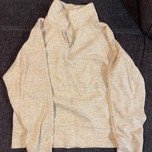 Small sized Nike 1/2 zip-up pullover in cream color.